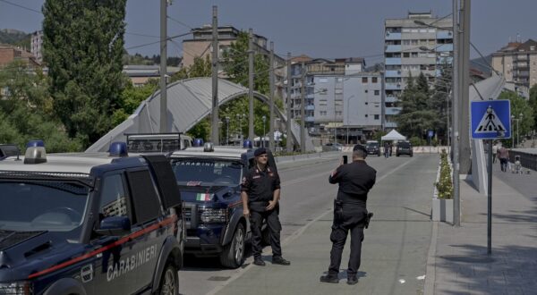 Italian Carabinieri members take pictures as they patrol at the Mitrovica bridge, that has long separated Serbs and ethnic Albanians in the restive northern area of Kosovo, in the divided city of Mitrovica on August 16, 2024. The bridge that divides the communities has been the scene of frequent clashes following the 1999 war between Serbian forces and Kosovo's ethnic Albanian majority, which left 13,000 dead and ended after a NATO bombing campaign led by Washington.,Image: 899159744, License: Rights-managed, Restrictions: , Model Release: no, Credit line: Armend NIMANI / AFP / Profimedia