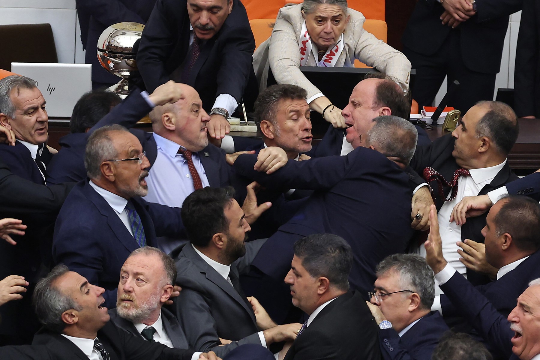 Turkish ruling and opposition lawmakers fight each other after a scuffle between former footballer Alpay Ozalan (unseen), a lawmaker from Erdogan's ruling AKP party and Turksih Workers Party (TIP) deputy Ahmet Sik (unseen) at Grand National Assembly of Turkey in Ankara on August 16,2024. A brawl broke out in Turkey's parliament on August 16, 2024, after lawmakers convened to discuss the status of a jailed opposition figure controversially stripped of his parliamentary immunity earlier this year. They were meeting after the country's constitutional court earlier this month struck down parliament's decision to oust Can Atalay from his parliamentary seat.,Image: 899211133, License: Rights-managed, Restrictions: , Model Release: no, Credit line: Adem ALTAN / AFP / Profimedia