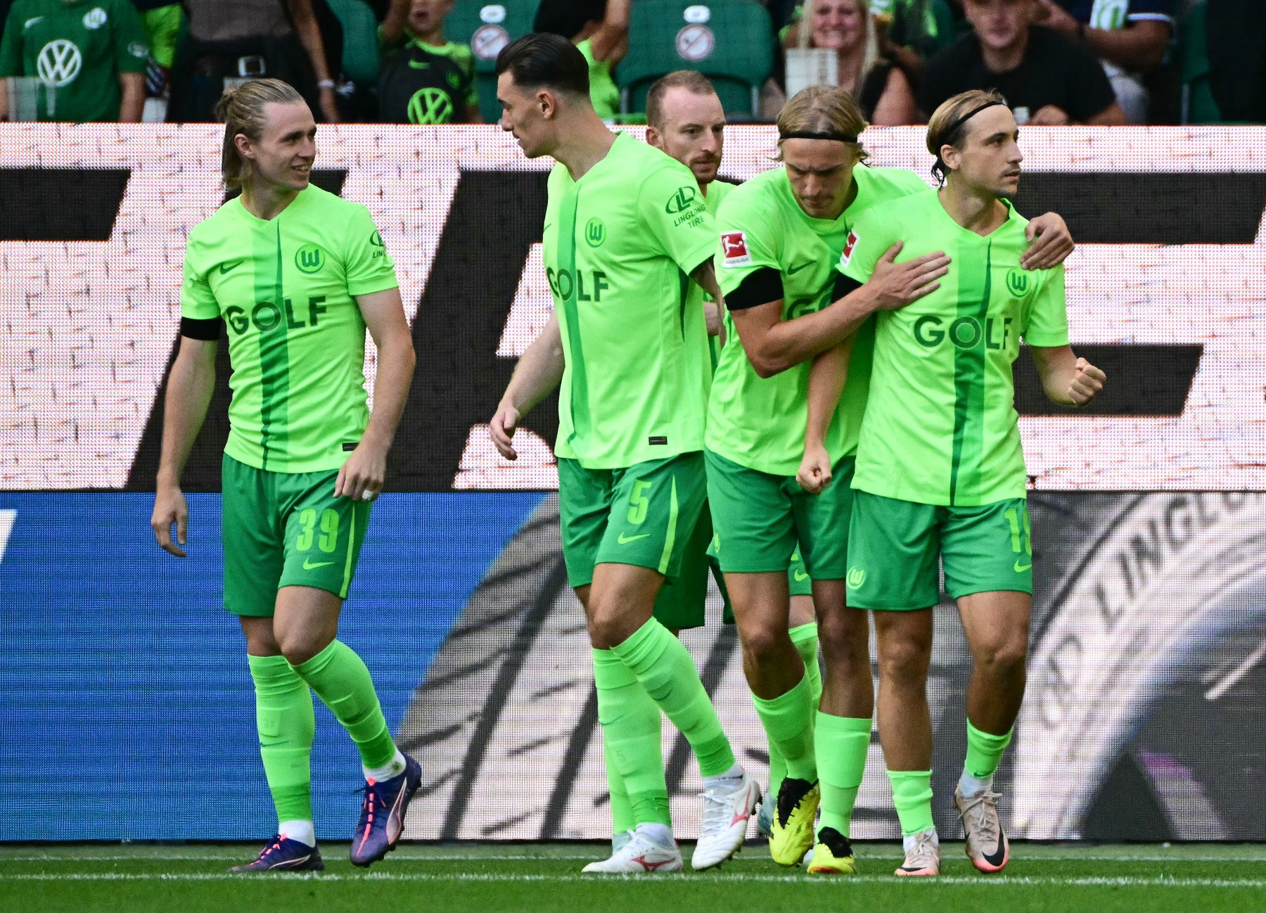 Wolfsburg's Croatian midfielder #19 Lovro Majer celebrates with teammates after scoring a penalty during the German first division Bundesliga football match between VfL Wolfsburg and FC Bayern Munich in Wolfsburg, northern Germany, on August 25, 2024.,Image: 901450833, License: Rights-managed, Restrictions: DFL REGULATIONS PROHIBIT ANY USE OF PHOTOGRAPHS AS IMAGE SEQUENCES AND/OR QUASI-VIDEO, Model Release: no, Credit line: Tobias SCHWARZ / AFP / Profimedia