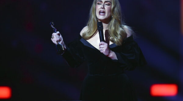 Adele on stage to accept her award for Artist of the Year at the Brit Awards 2022 in London Tuesday, Feb. 8, 2022. (Photo by Joel C Ryan/Invision/AP)