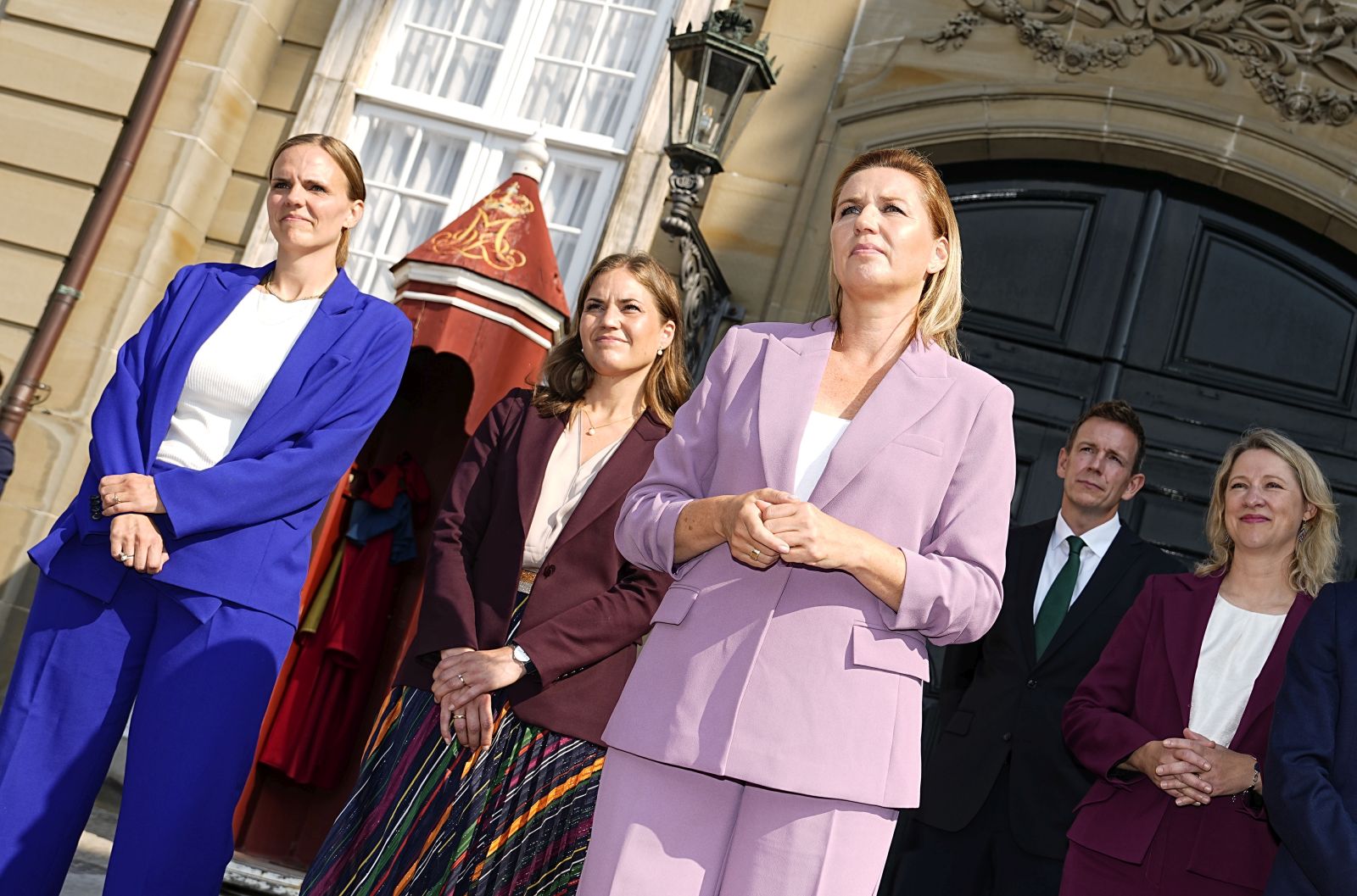 epa11570775 Danish Prime Minister Mette Frederiksen (C) speaks during the presentation of the new ministers in front of Frederik VIII's Palace, one of the four palaces of Amalienborg, in Copenhagen, Denmark, 29 August 2024. (L-R) Minister for Digitisation Caroline Stage Olsen, European Minister Marie Bjerre, Danish Prime Minister Mette Frederiksen, Tax Minister Rasmus Stoklund, Social and Housing Minister Sophie Haestorp Andersen, Minister for Green Tripartite Jeppe Bruus and Minister for Community Safety and Preparedness Torsten Schack Pedersen.  EPA/MADS CLAUS RASMUSSEN  DENMARK OUT