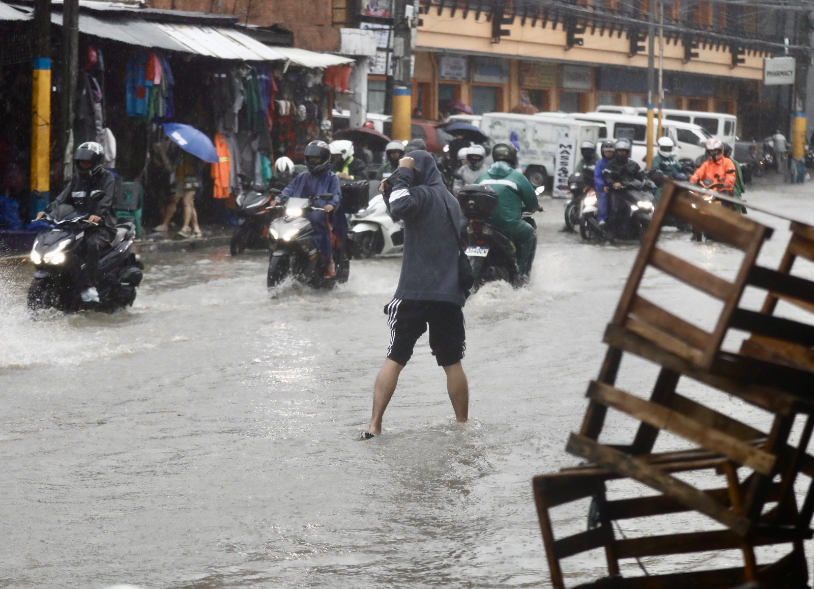 epa11579028 Motorists maneuver along a flooded road in Bacoor city, Cavite province, about 30 kilometers south-east of Manila, Philippines, 02 September 2024. In a report by the National Disaster Risk Reduction and Management (NDRRMC) on 02 September, two people were dead and scores injured as a result of conditions brought by Tropical Storm Yagi. The state weather agency of the Philippines warned residents living along the typhoon path to take precautionary measure due to possible flash floods in low-lying areas and landslides in mountainous villages.  EPA/FRANCIS R. MALASIG