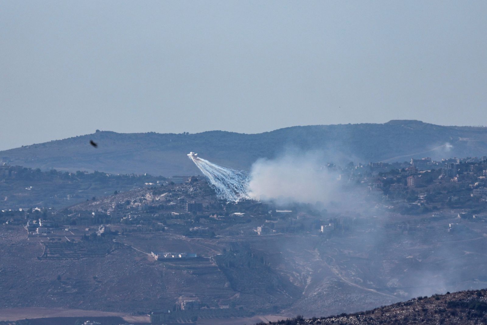 epa11598672 Israeli artillery shells an area of Al-Khiam in southern Lebanon, as seen from the Upper Galilee, northern Israel, 11 September 2024. The Israeli military stated that approximately 30 projectiles were identified crossing from Lebanese territory into Israel and fell in an open area.  EPA/ATEF SAFADI