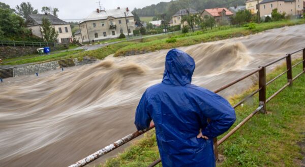 epa11603538 A local man looks at the overflowing Bela river in Mikulovice, Czech Republic, 14 September 2024. The Czech Hydrometeorological Institute (CHMU) has issued a extreme precipitation warning of unusually intense rainfall which can significantly raise water levels and that will affect the Czech Republic from 12 September until the end of the week.  EPA/MARTIN DIVISEK