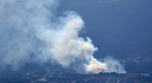 epa11611961 Smoke rises as a result of projectiles fired from southern Lebanon over Kiryat Shmona, northern Israel, 18 September 2024. The Israeli military stated that several missiles fired from Lebanon crossed into Israeli territory and were intercepted by the Iron Dome air defense system.  EPA/ATEF SAFADI