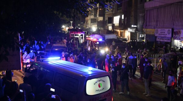 epaselect epa11616181 People and emergency personnel gather in front of a damaged building after an Israeli military strike, in Beirut, Lebanon, 20 September 2024. At least eight people were killed and dozens injured in the attack, which targeted the southern suburb of Beirut, according to the Lebanese Ministry of Health. The Israeli military stated on 20 September that it conducted a 'targeted strike' in Beirut, claiming that the 'Hezbollah Commanders we eliminated today' had been planning attacks on northern areas of Israel.  EPA/WAEL HAMZEH