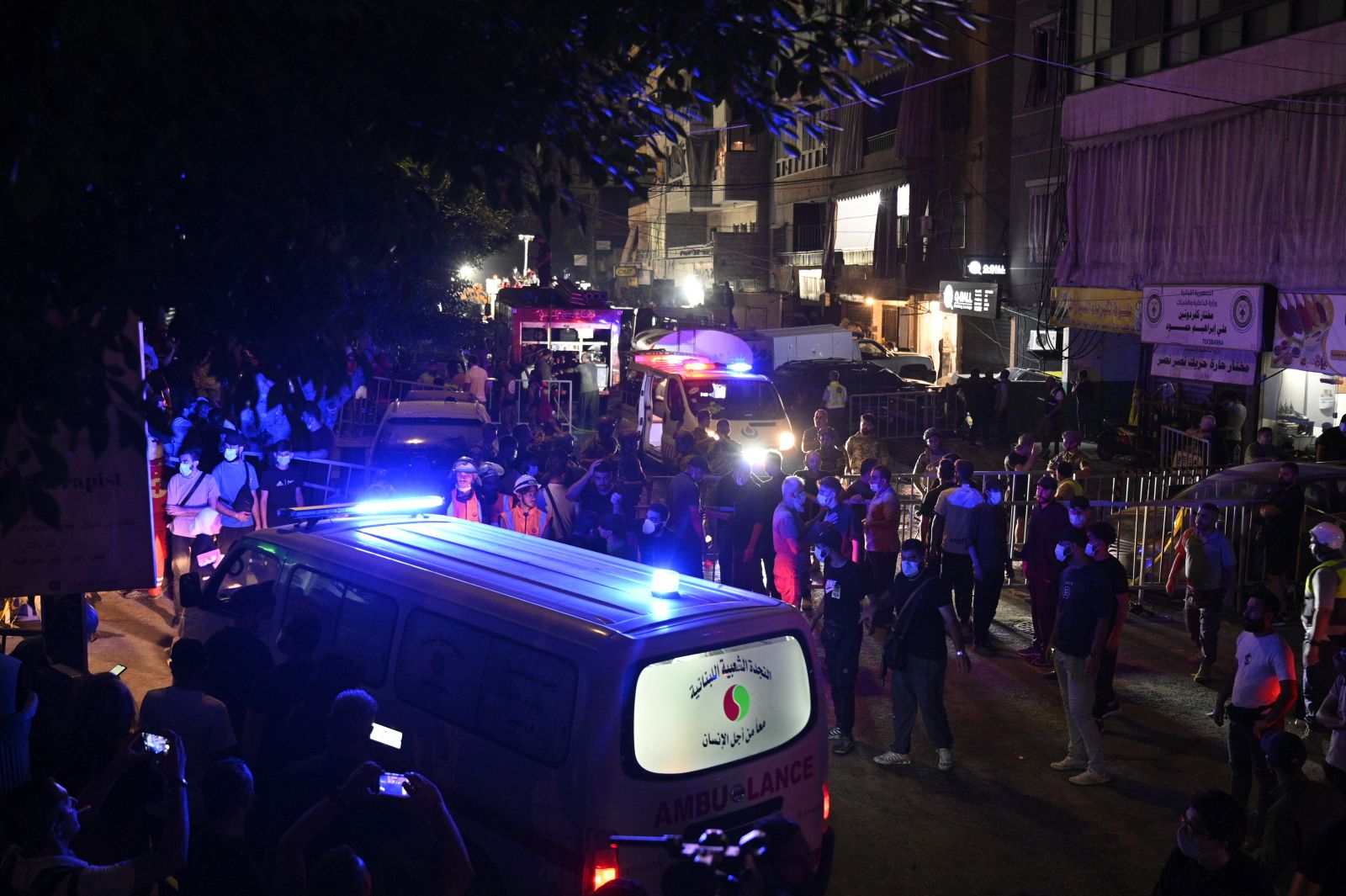 epaselect epa11616181 People and emergency personnel gather in front of a damaged building after an Israeli military strike, in Beirut, Lebanon, 20 September 2024. At least eight people were killed and dozens injured in the attack, which targeted the southern suburb of Beirut, according to the Lebanese Ministry of Health. The Israeli military stated on 20 September that it conducted a 'targeted strike' in Beirut, claiming that the 'Hezbollah Commanders we eliminated today' had been planning attacks on northern areas of Israel.  EPA/WAEL HAMZEH