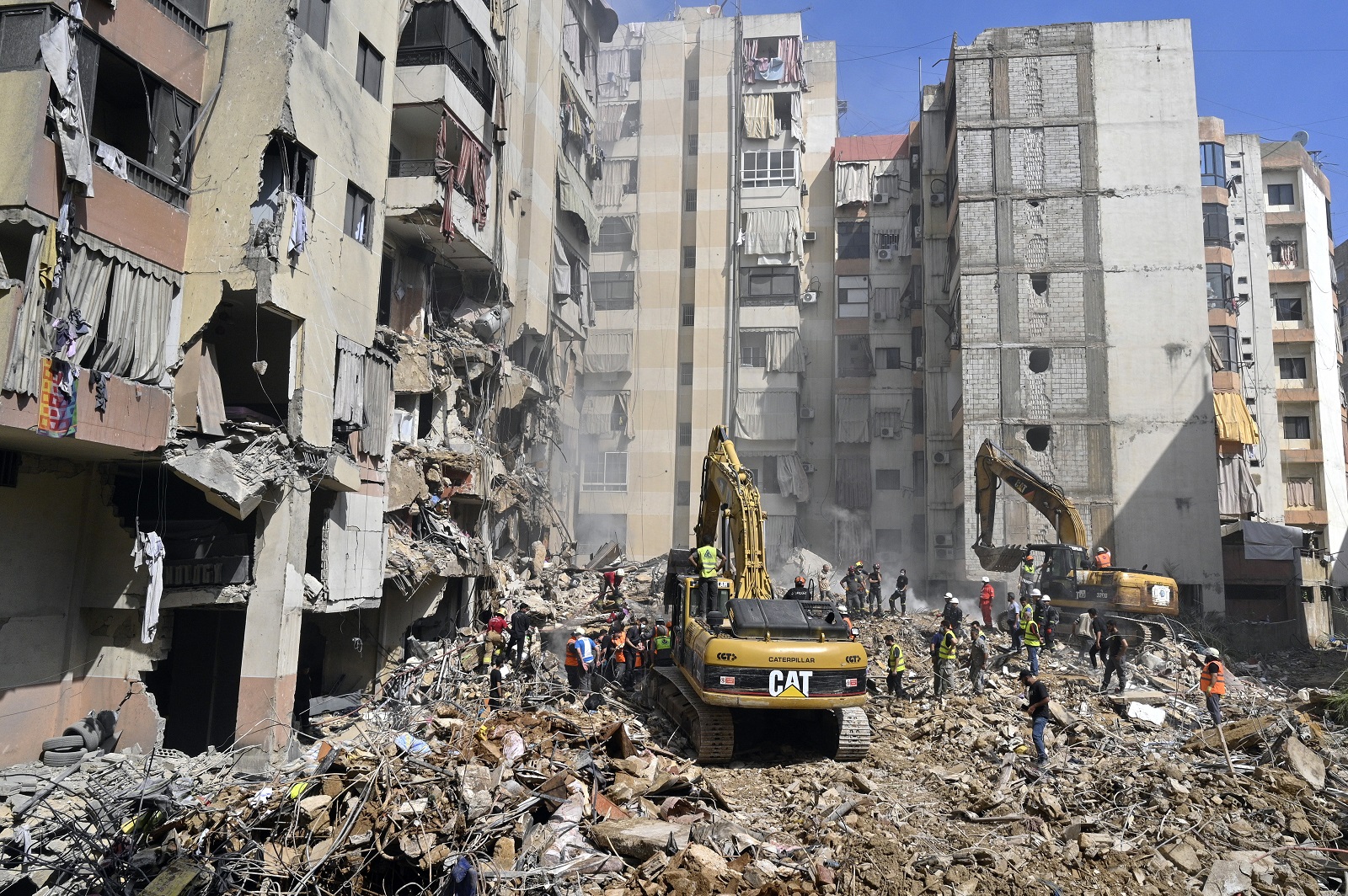 epa11616876 Emergency workers use excavators to clear the rubble at the site which was targeted by an Israeli strike the previous day, in the southern suburb of Beirut, Lebanon, 21 September 2024. At least thirty-one people, including Hezbollah commander Ibrahim Akil, were killed and dozens injured in an attack which targeted the southern suburb of Beirut, according to the Lebanese Ministry of Health. The Israeli military stated on 20 September that it conducted a 'targeted strike' in Beirut, claiming that the 'Hezbollah Commanders we eliminated today' had been planning attacks on northern areas of Israel.  EPA/WAEL HAMZEH