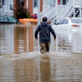 epa11628778 A man wades through the flood waters at the Peachtree Park Apartments after Tropical Storm Helene raced through Atlanta, Georgia, USA, 27 September 2024. Hurricane Helene made landfall near Perry, Florida and several deaths have been reported in Georgia.  EPA/ERIK S. LESSER