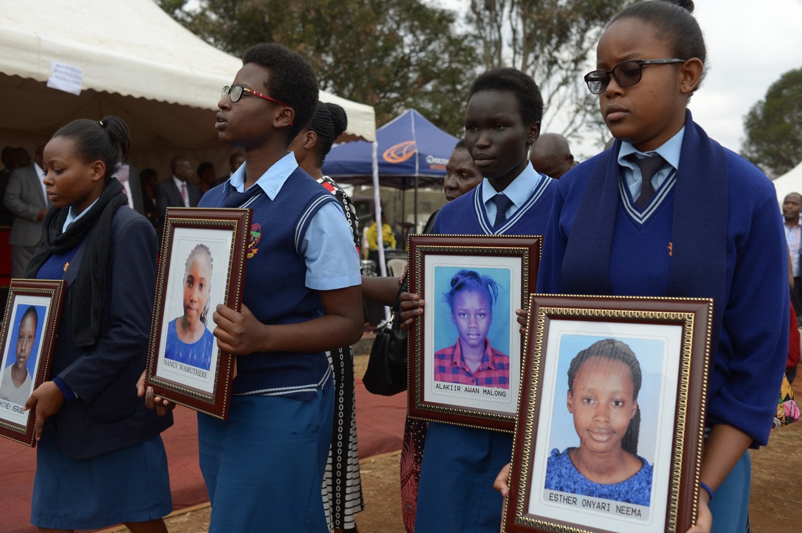 Students carry the photo's accompanied by  relatives of the girls who died in the Moi Girls School dormitory fire, September 14, 2017 attend a requiem mass at the school in Nairobi. A 14-year-old Kenyan girl was charged on September 13 with multiple counts of murder for allegedly starting a fire at a Nairobi school dormitory that left nine other schoolgirls dead. According to a source inside the court, where proceedings were held in camera due to the age of the accused, the girl denied starting the fire on September 2 at the Moi Girls High School.,Image: 349356340, License: Rights-managed, Restrictions: , Model Release: no, Credit line: SIMON MAINA / AFP / Profimedia