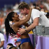 Paris 2024 Olympics - Athletics - Women's Long Jump Final - Stade de France, Saint-Denis, France - August 08, 2024. Tara Davis-Woodhall of United States celebrates with her husband Hunter Woodhall after winning gold. REUTERS/Dylan Martinez Photo: Dylan Martinez/REUTERS