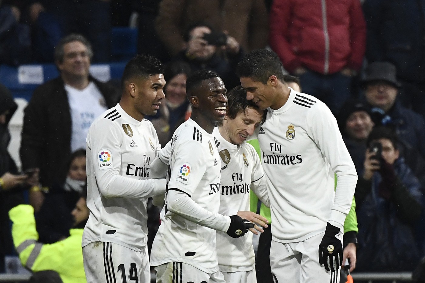 Real Madrid's Croatian midfielder Luka Modric (2L) celebrates with Real Madrid's Brazilian midfielder Casemiro, Real Madrid's Brazilian forward Vinicius Junior and Real Madrid's French defender Raphael Varane after scoring a goal during the Spanish League football match between Real Madrid and Sevilla at the Santiago Bernabeu stadium in Madrid on January 19, 2019.,Image: 408685920, License: Rights-managed, Restrictions: , Model Release: no, Credit line: PIERRE-PHILIPPE MARCOU / AFP / Profimedia