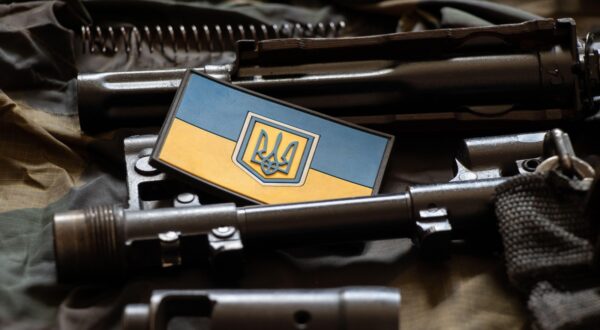 The patch of the flag of Ukraine lies on a disassembled machine gun on a green camouflage fabric, war in Ukraine, military weapons,Image: 702542404, License: Royalty-free, Restrictions: , Model Release: no, Credit line: / Alamy / Alamy / Profimedia