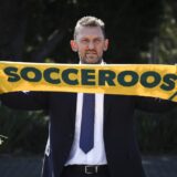 Tony Popovic, the newly-appointed head coach for Australia's national football team, poses with a scarf after a press conference in Sydney on September 23, 2024. Football Australia appointed former Crystal Palace defender Tony Popovic as the new Socceroos coach on September 23, tasking him with rescuing their faltering World Cup qualifying campaign.,Image: 910930579, License: Rights-managed, Restrictions: -- IMAGE RESTRICTED TO EDITORIAL USE - STRICTLY NO COMMERCIAL USE --, Model Release: no, Credit line: DAVID GRAY / AFP / Profimedia