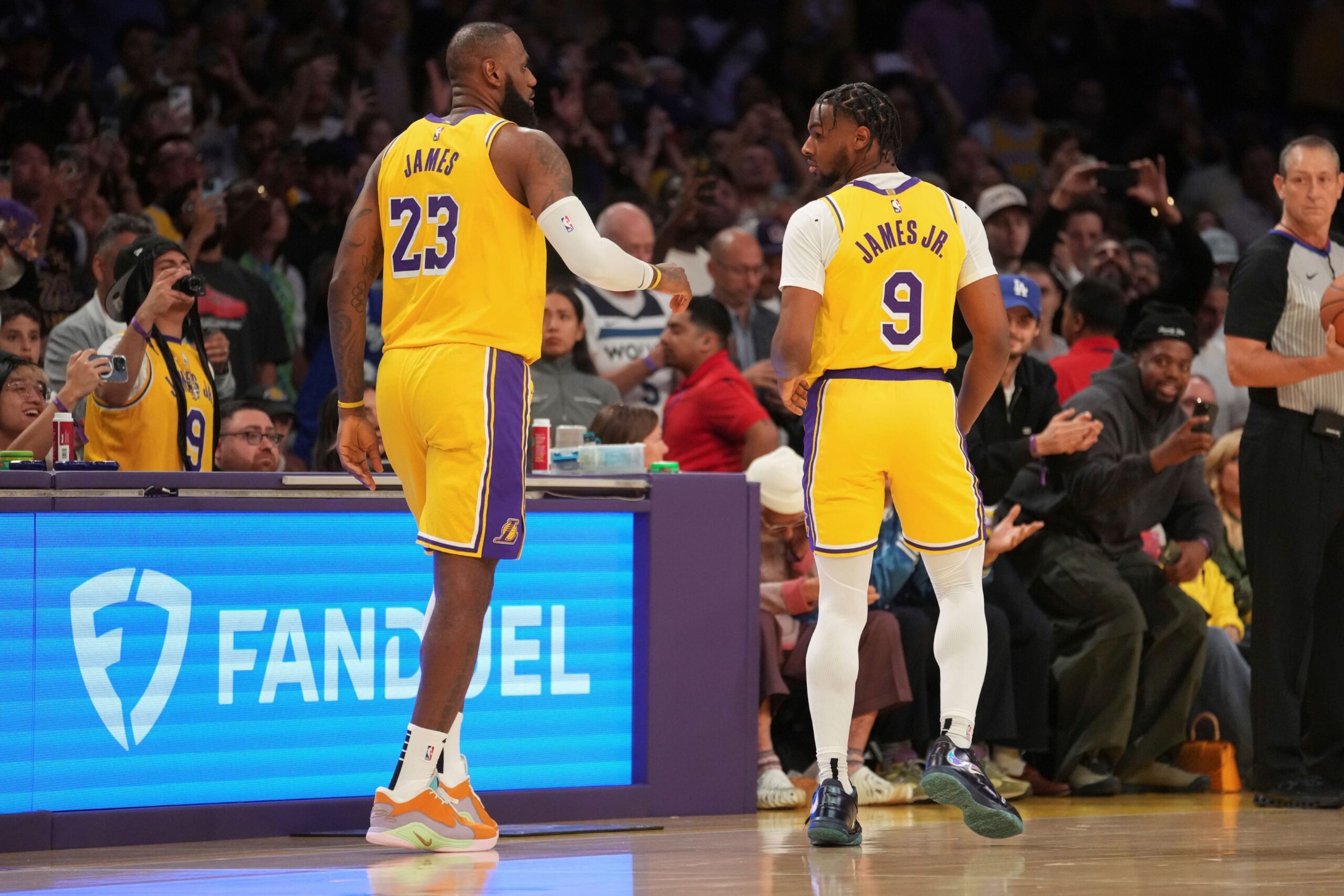 Los Angeles Lakers forward LeBron James (23) and guard Bronny James (9) stand on the court during the first half of an NBA basketball game against the Minnesota Timberwolves, Tuesday, Oct. 22, 2024, in Los Angeles. (AP Photo/Eric Thayer) Timberwolves Lakers Basketball