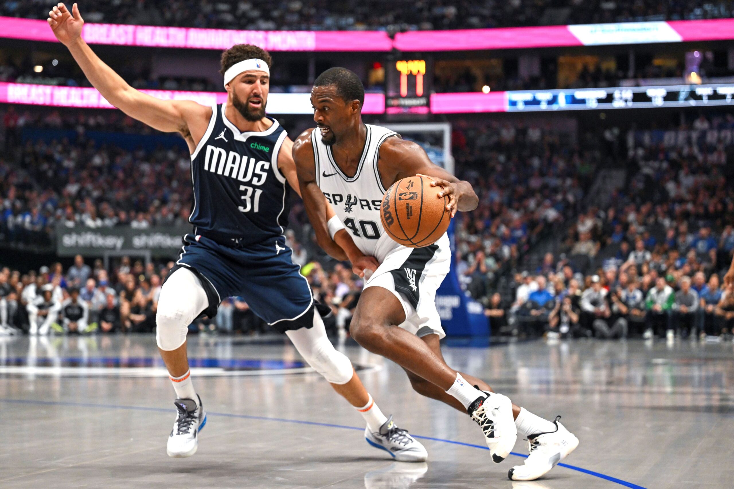 San Antonio Spurs' Harrison Barnes (40) drives against Dallas Mavericks' Klay Thompson (31) during the second half of an NBA basketball game, Thursday, Oct. 24, 2024, in Dallas, Texas. (AP Photo/Albert Pena) Spurs Mavericks Basketball