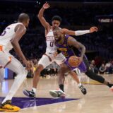 Los Angeles Lakers forward LeBron James (23) drives against Phoenix Suns forwards Kevin Durant, left, and Ryan Dunn (0) during the second half of an NBA basketball game in Los Angeles, Friday, Oct. 25, 2024. (AP Photo/Eric Thayer) Suns Lakers Basketball