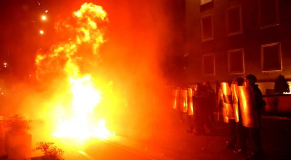 Riot police officers stand in a street as molotov cocktails explode outside the government building, thrown by opposition protesters who demand the resignation of the government and the release of opposition MP Ervin Salianji, in Tirana, on October 7, 2024. Clashes broke out late Monday in Tirana between police and opposition protesters seeking that longtime leftist Prime Minister Edi Rama resigns, leaving 10 officers injured police said. A few thousand people gathered in the Albanian capital at demonstrations organised by the country's right-wing opposition, according to an AFP reporter.,Image: 917830156, License: Rights-managed, Restrictions: , Model Release: no, Credit line: Adnan Beci / AFP / Profimedia