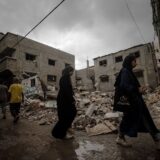 epa11635336 Palestinians walk past a destroyed house following an Israeli air strike in Al Nusairat refugee camp, central Gaza Strip, 01 October 2024. More than 41,000 Palestinians and over 1,400 Israelis have been killed, according to the Palestinian Health Ministry and the Israel Defense Forces (IDF), since Hamas militants launched an attack against Israel from the Gaza Strip on 07 October 2023, and the Israeli operations in Gaza and the West Bank which followed it.  EPA/MOHAMMED SABER