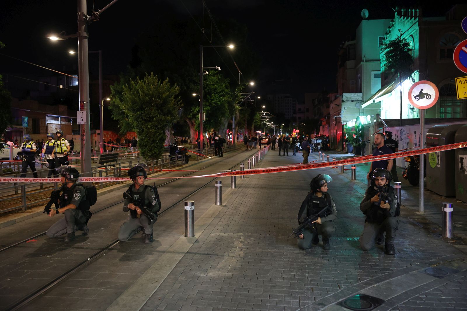 epa11636266 Armed Israeli police officers keep watch near a cordon at the site of a shooting incident in Tel Aviv, Israel, 01 October 2024. According to Israeli police, at least eight people were killed and nine others wounded in a shooting incident on Sderot Yerushalim in Tel Aviv. Two gunmen have been 'neutralized' on site, police said.  EPA/ABIR SULTAN