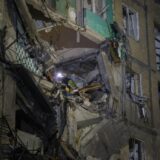 epa11639191 Ukrainian rescuers work at the site of a shelling on a residential building in Kharkiv, northeastern Ukraine, late 02 October 2024 (issued 03 October 2024), amid the ongoing Russian invasion. At least 10 people were injured, including a three-year-old girl, following a Russian glide bomb shelling in a residential area of Kharkiv, according to the State Emergency Service of Ukraine.  EPA/SERGEY KOZLOV