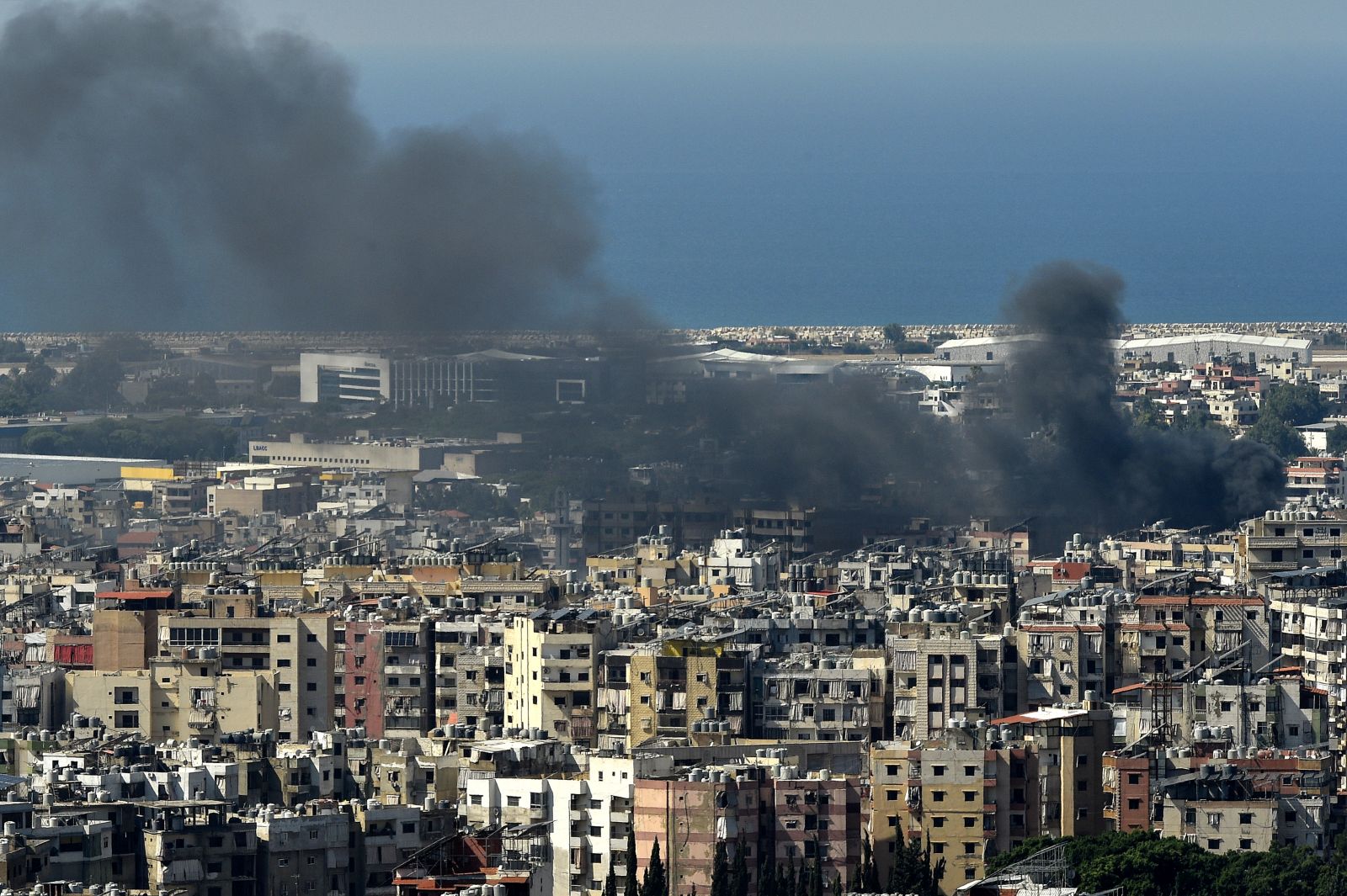 epa11643183 Smoke rises over residential buildings following an Israeli airstrike in the Hezbollah stronghold of Dahieh, a southern suburb of Beirut, Lebanon, 05 October 2024. Lebanese Minister of Health, Firas Abiad, announced on 04 October, that nearly 2,000 people have been killed and more than 9,300 others have been injured in Lebanon since the beginning of the Hezbollah-Israeli conflict.  EPA/WAEL HAMZEH