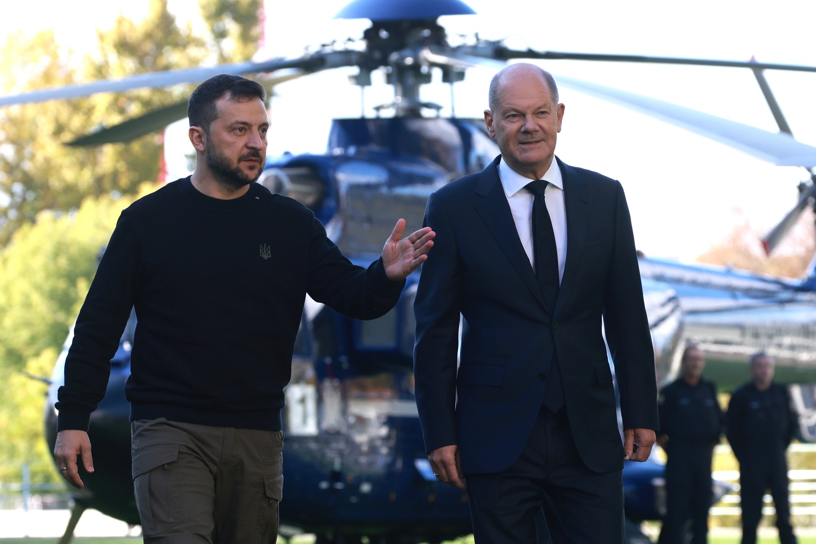 epa11654642 German Chancellor Olaf Scholz (R) and Ukrainian President Volodymyr Zelensky (L) walk in front of a helicopter at the chancellery in Berlin, Germany, 11 October 2024. Zelensky is on a visit to Germany after visiting France and Italy.  EPA/CLEMENS BILAN