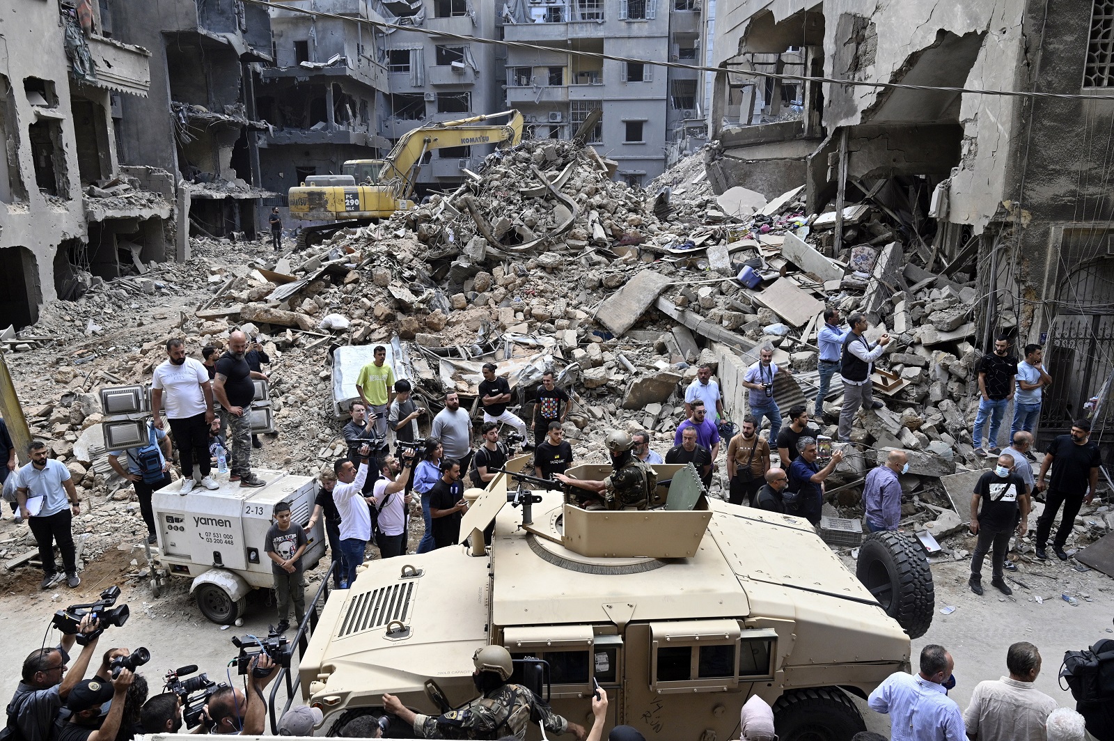 epa11655795 A Lebanese army vehicle drives as security personnel and members of the media wait for the arrival of the Speaker of the Parliament of Iran in the Basta neighborhood that was hit by an Israeli military strike in Beirut, Lebanon, 12 October 2024. At least 22 people were killed and 117 injured in an Israeli military strike in Beirut, Lebanon's Ministry of Public Health stated on 10 October. According to the Lebanese Ministry of Health, more than 2,100 people have been killed and over 10,000 others have been injured in Lebanon since Israel expanded its military operations to Lebanon in September 2024.  EPA/WAEL HAMZEH