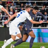 epa11657477 Arttu Hoskonen (C) of Finland and Jude Bellingham (R) of England in action during the UEFA Nations League group B match between Finland and England in Helsinki, Finland, 13 October 2024.  EPA/Kimmo Brandt