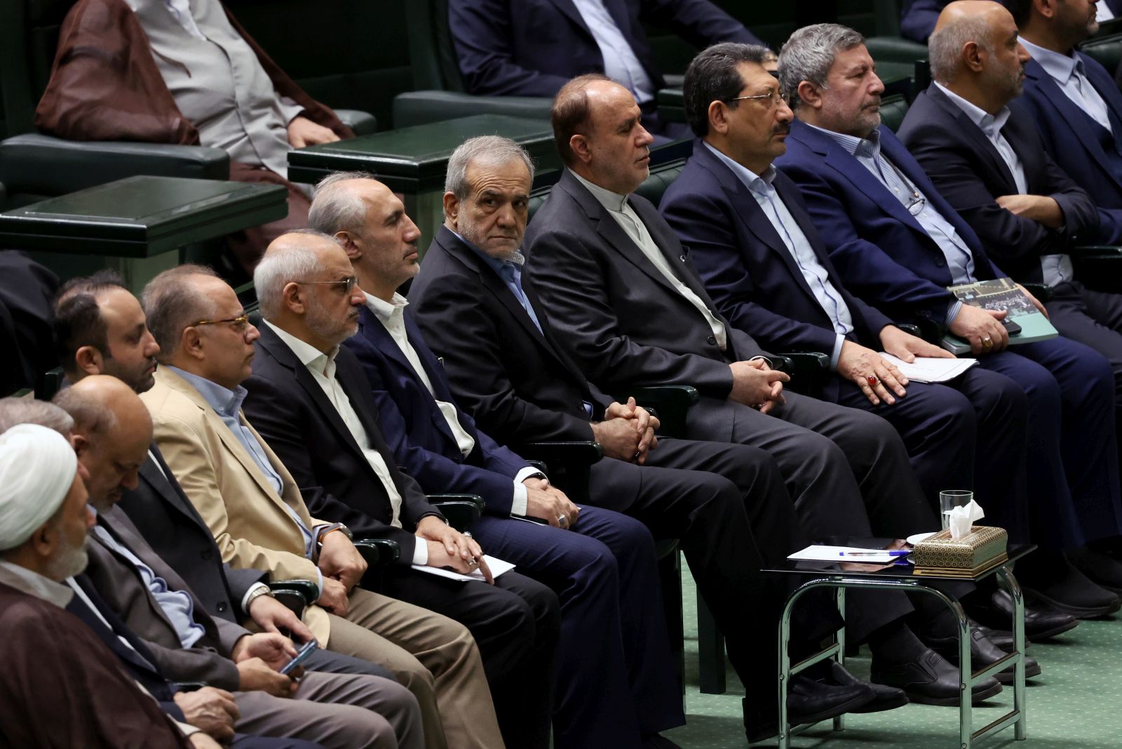 epa11674214 Iranian president Masoud Pezeshkian (C) attends the parliament session in Tehran, Iran, 22 October 2024. Iranian President Masoud Pezeshkian presented a draft state budget to the parliament for the coming Persian year 1404 that will start on 21 March 2025.  EPA/ABEDIN TAHERKENAREH