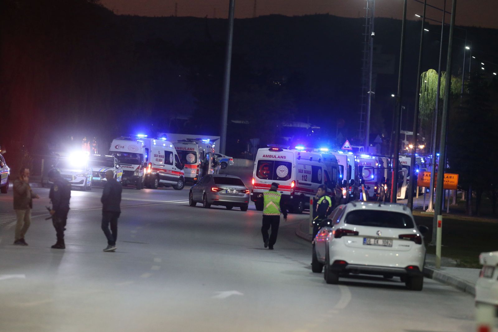 epa11677748 Ambulances arrive as policemen secure the area during a terror attack at (TUSAS) Turkish Aerospace and Aviation Center's headquearter in Ankara, Turkey 23 Ocober 2024. Turkish Interior Minister Ali Yerlikaya announced that four people were killed and 14 were injured in the terrorist attack. Two terrorists were also killed by security forces following an explosion at the headquarters of the Turkish aviation firm close to Ankara.  EPA/NECATI SAVAS