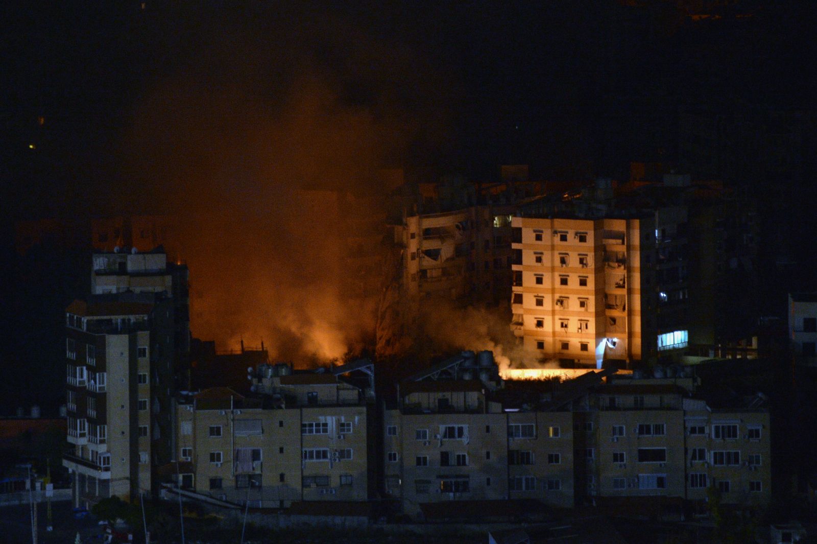 epa11678906 Flames and smoke rise from buildings as a result of Israeli airstrikes at Dahieh in the southern suburb of Beirut, Lebanon, early 24 October 2024. Israeli airstrikes hit Dahieh in the southern suburb of Beirut after the Israeli Army issued warnings to evacuate the buildings. According to the Lebanese Ministry of Health, more than 2,400 people have been killed and over 11,600 others have been injured in Lebanon since the start of recent escalations of hostilities.  EPA/WAEL HAMZEH