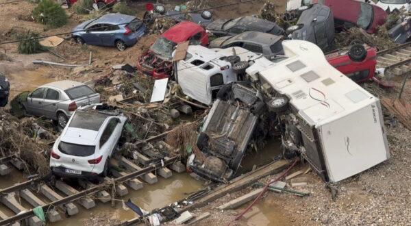 epa11692826 Damaged cars and debris are stacked in the middle of a tran rail in the flood-hit city of Alfafar, in the province of Valencia, Spain, 30 October 2024. The intense rainfall impacting the eastern part of the country resulted in at least 70 lives being lost in the province of Valencia and neighboring provinces due to the flooding. The State Meteorological Agency (AEMET) issued orange and red alerts for rainfall in multiple regions of east and southern Spain due to a DANA (isolated depression at high levels) phenomenon.  EPA/RAQUEL SEGURA