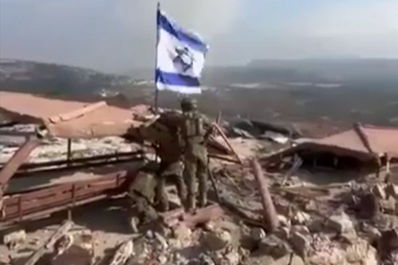 An image grab taken from a UGC video posted on social media on October 8, 2024 shows Israeli soldiers raising an Israeli flag in Lebanon's southern border village of Maroun al-Ras. Hezbollah said it had forced Israeli troops to retreat on October 8 after they crossed into Lebanon near a UN peacekeeping (UNIFIL) post following Israel's announcement last week it was conducting ground incursions.,Image: 918242524, License: Rights-managed, Restrictions: RESTRICTED TO EDITORIAL USE – MANDATORY CREDIT «  AFP PHOTO / UGC / ANONYMOUS  » - NO MARKETING NO ADVERTISING CAMPAIGNS – DISTRIBUTED AS A SERVICE TO CLIENTS [NO ARCHIVE]
BEST QUALITY AVAILABLE, ***
HANDOUT image or SOCIAL MEDIA IMAGE or FILMSTILL for EDITORIAL USE ONLY! * Please note: Fees charged by Profimedia are for the Profimedia's services only, and do not, nor are they intended to, convey to the user any ownership of Copyright or License in the material. Profimedia does not claim any ownership including but not limited to Copyright or License in the attached material. By publishing this material you (the user) expressly agree to indemnify and to hold Profimedia and its directors, shareholders and employees harmless from any loss, claims, damages, demands, expenses (including legal fees), or any causes of action or allegation against Profimedia arising out of or connected in any way with publication of the material. Profimedia does not claim any copyright or license in the attached materials. Any downloading fees charged by Profimedia are for Profimedia's services only. * Handling Fee Only 
***, Model Release: no, Credit line: AFP / AFP / Profimedia