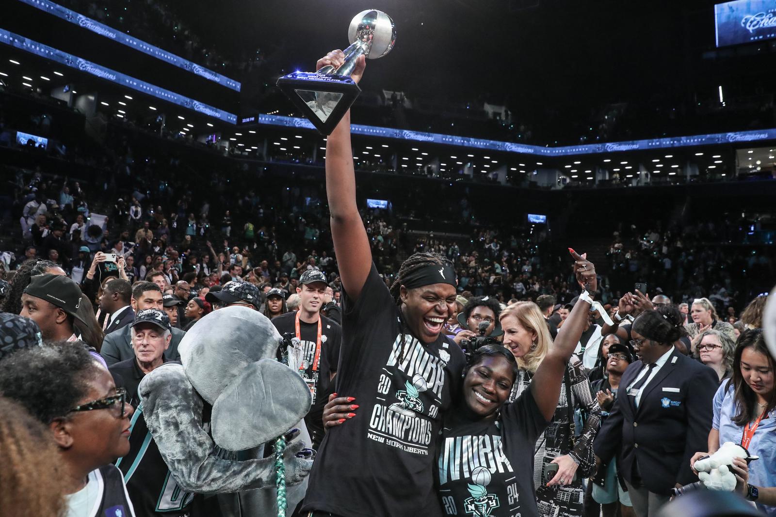 Oct 20, 2024; Brooklyn, New York, USA; New York Liberty forward Jonquel Jones (35) holds up the MVP trophy after defeating the Minnesota Lynx in overtime to win the 2024 WNBA Finals at Barclays Center. Mandatory Credit: Wendell Cruz-Imagn Images Photo: Wendell Cruz/REUTERS