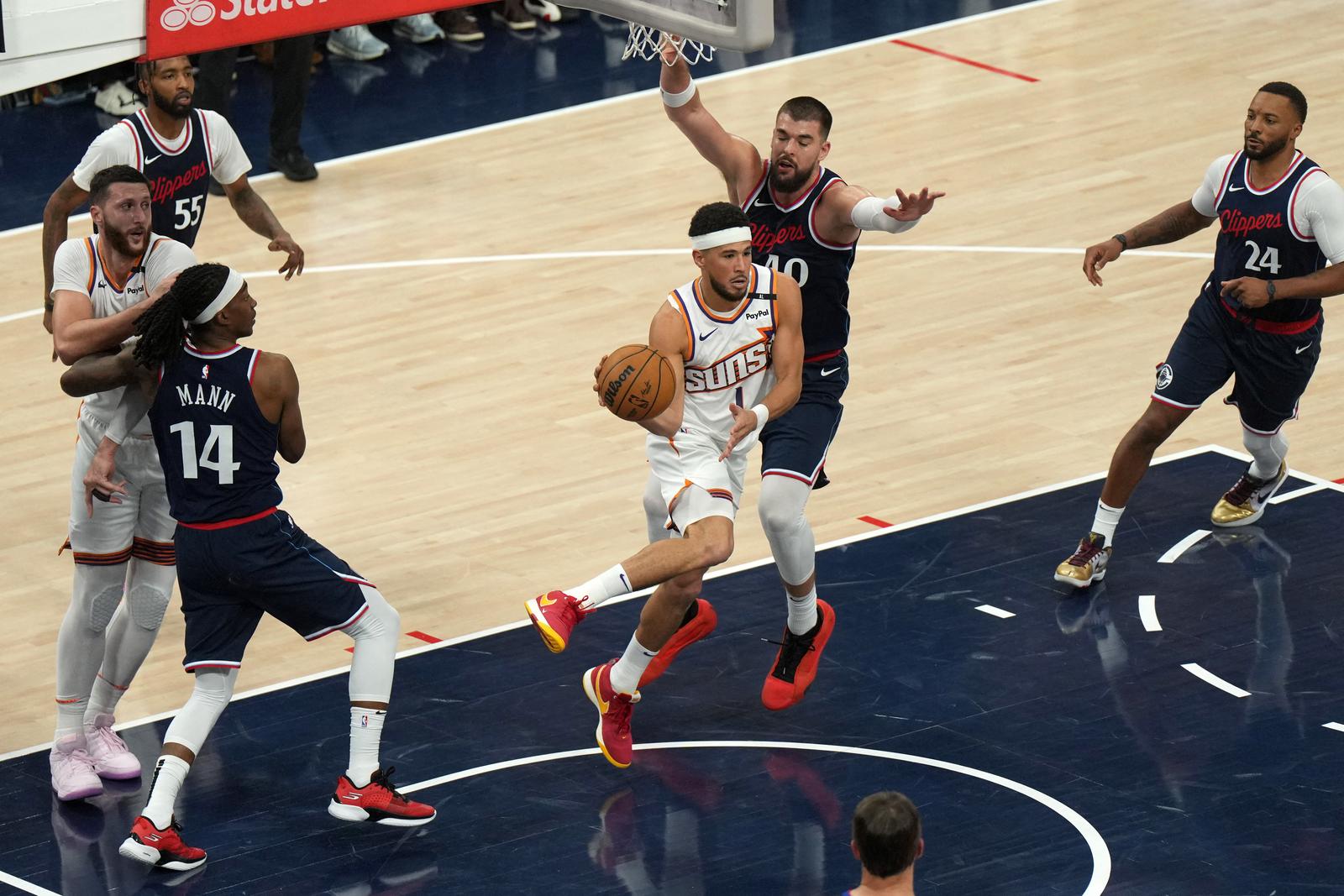 Oct 23, 2024; Inglewood, California, USA; Phoenix Suns guard Devin Booker (1) is defended by LA Clippers center Ivica Zubac (40) in the first half  at Intuit Dome. Mandatory Credit: Kirby Lee-Imagn Images Photo: Kirby Lee/REUTERS