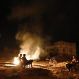 Palestinian men sit next to a fire amid destroyed homes on their block in Shejaiya on August 27, 2014. Shejaiya was one of the hardest hit neighborhoods in fighting between Hamas militants and Israel during 50 days of fighting. The fire was set by the home owners in an effort to keep mosquitoes away from their shattered homes. Israel and Palestinians both boasted of victory in the Gaza war but analysts say Hamas received only promises while the conflict aggravated divisions in the Israeli leadership.,Image: 203136918, License: Rights-managed, Restrictions: , Model Release: no, Credit line: ROBERTO SCHMIDT / AFP / Profimedia