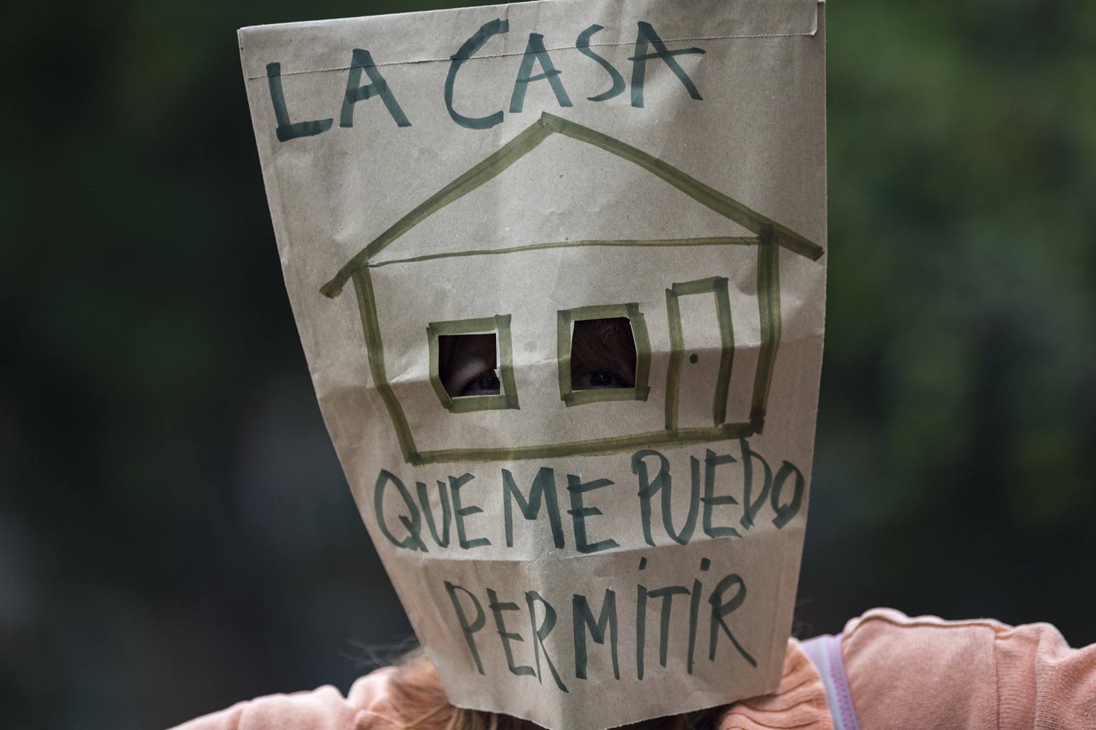 October 13, 2024, Madrid, Madrid, Spain: A woman with a paper bag over her face, which reads in Spanish ''The house I can afford'' during a protest to demand lower rental prices and better rental conditions, which took place in the streets of Madrid.,Image: 920492563, License: Rights-managed, Restrictions: , Model Release: no, Credit line: Luis Soto / Zuma Press / Profimedia