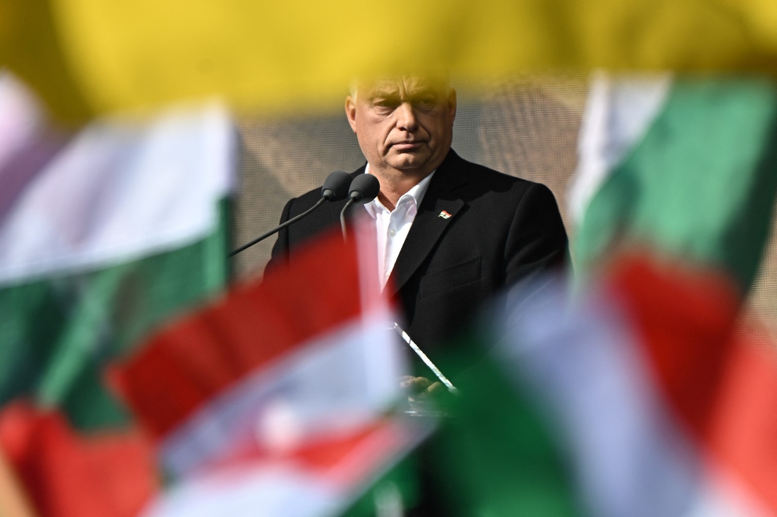 Hungary's Prime Minister Viktor Orban is seen between flags as he delivers a speech during an event to commemorate the 68th anniversary of the Hungarian uprising against the Soviet occupation, in the Millenaris culture center of Budapest, on October 23, 2024.  The uprising began in Budapest after a student demonstration on October 23, 1956 and had been crushed on November 4 by Soviet Red Army tanks. More than 2,000 civilians were killed during the fighting, while around 200,000 people fled the country.,Image: 925310304, License: Rights-managed, Restrictions: , Model Release: no, Credit line: Attila KISBENEDEK / AFP / Profimedia