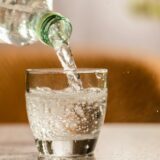 Close up the pouring purified fresh drink water from the bottle on table in living room,Image: 854059887, License: Royalty-free, Restrictions: , Model Release: no, Credit line: Jacek Dudzinski / Panthermedia / Profimedia