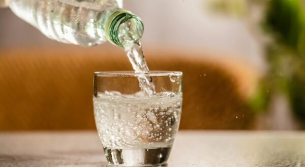 Close up the pouring purified fresh drink water from the bottle on table in living room,Image: 854059887, License: Royalty-free, Restrictions: , Model Release: no, Credit line: Jacek Dudzinski / Panthermedia / Profimedia