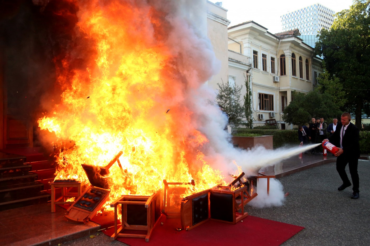 Members of the National Guard extinguish a fire set by opposition MPs by burning their Parliament chairs in front of the Parliament in protest of the arrest of their colleague opposition MP Ervin Salianji in Tirana on September 30, 2024. Leader of centre-right Democratic Party, Ervin Salianji was sentenced to one-year imprisonment and convicted of "giving false evidence" in a drug trafficking case involving the brother of a Socialist MP. Judges suspected certain members of the opposition of having produced false recordings.,Image: 914242360, License: Rights-managed, Restrictions: , Model Release: no, Credit line: ADNAN BECI / AFP / Profimedia