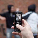 Two boys fighting on the playground while a third films with his cell phone, posed scene,Image: 88633793, License: Rights-managed, Restrictions: , Model Release: yes, Credit line: Siegfried Kuttig / imageBROKER / Profimedia