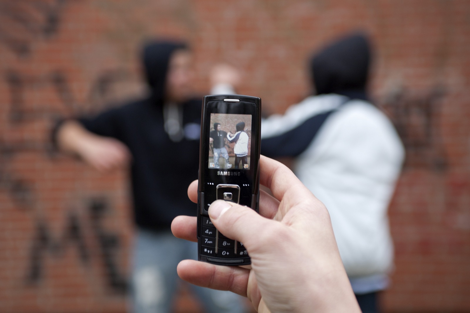 Two boys fighting on the playground while a third films with his cell phone, posed scene,Image: 88633793, License: Rights-managed, Restrictions: , Model Release: yes, Credit line: Siegfried Kuttig / imageBROKER / Profimedia