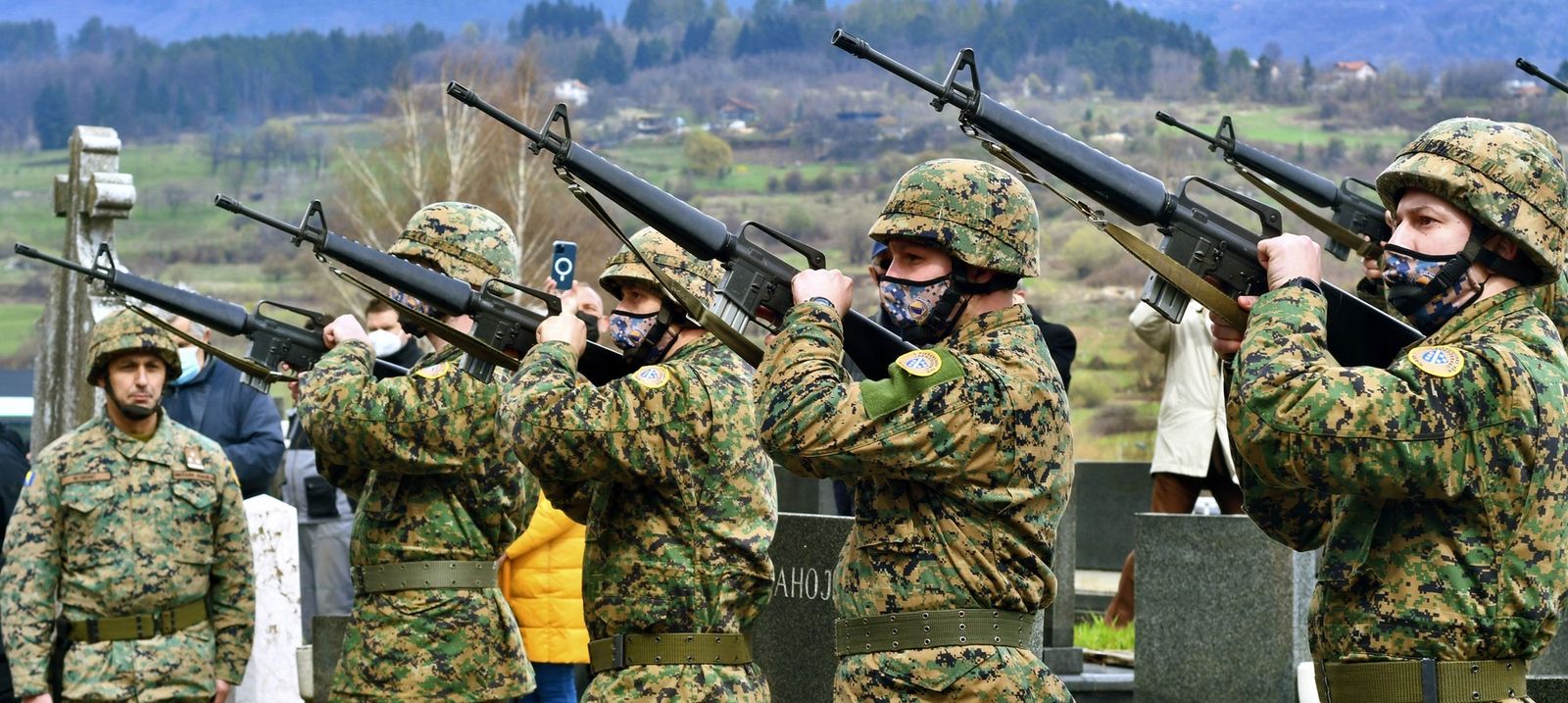 Military personnel aim up with automatic rifles as hundreds of citizens of Sarajevo gather to pay their respects during the funeral of former Bosnian army general Jovan Divjak at Sarajevo's Bare Cemetery on April 13, 2021. Serbian born, Jovan Divjak (84) died on April 9, 2021 in Sarajevo. Citizens of Bosnian capital showed their gratitude to Divjak as one of rare Serbs who helped in resisting the powerful armed machinery from Serbia in it's attempt to occupy Sarajevo in April 1992, at the beginning of what will later become known as the longest siege of a city in modern war history.,Image: 605264050, License: Rights-managed, Restrictions: , Model Release: no, Credit line: STR/AFP/Profimedia