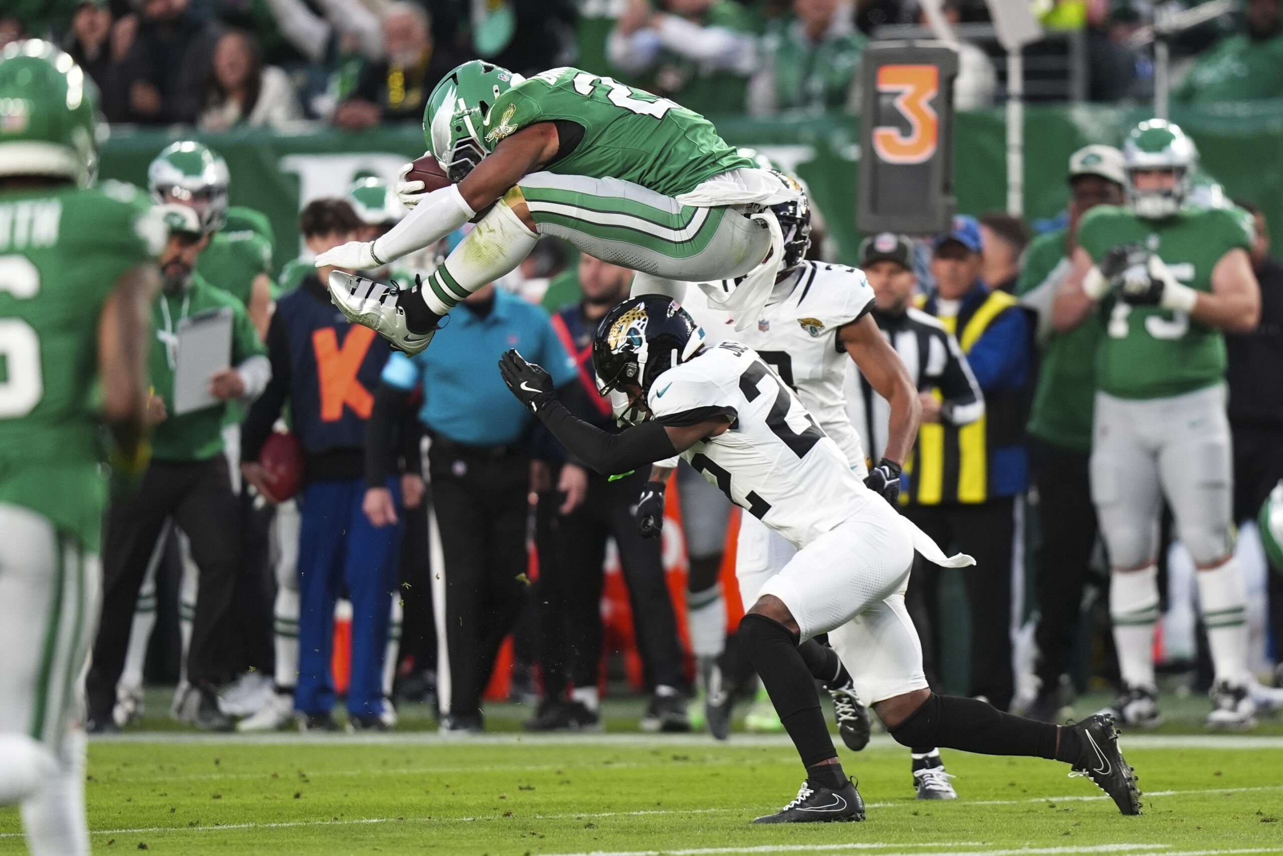 Philadelphia Eagles running back Saquon Barkley (26) hurdles over Jacksonville Jaguars cornerback Jarrian Jones (22) during the first half of an NFL football game Sunday, Nov. 3, 2024, in Philadelphia. (AP Photo/Chris Szagola)