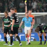 Manchester City's Mateo Kovacic, center, receives a yellow card during the UEFA Champions League opening phase match between Sporting and Manchester City in Lisbon, Portugal, Tuesday, Nov. 5, 2024. (AP Photo/Armando Franca) Portugal Soccer Champions League