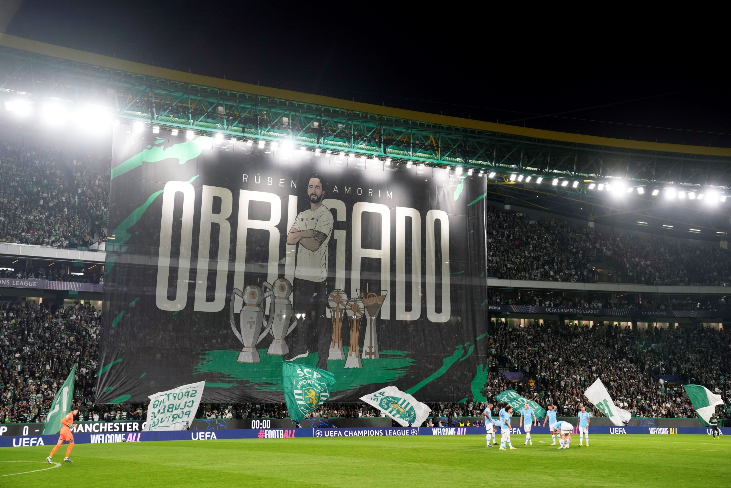 A giant banner is unfurled with a picture of Sporting's head coach Ruben Amorim and the Portuguese word for Thank You before the Champions League opening phase soccer match between Sporting CP and Manchester City at the Alvalade stadium in Lisbon, Tuesday, Nov. 5, 2024. (AP Photo/Armando Franca) Portugal Soccer Champions League