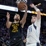 Golden State Warriors guard Stephen Curry (30) shoots against Dallas Mavericks guard Luka Doncic (77) during the second half of an Emirates NBA Cup basketball game in San Francisco, Tuesday, Nov. 12, 2024. (AP Photo/Jeff Chiu) Mavericks Warriors Basketball