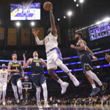 Los Angeles Lakers forward LeBron James (23) shoots as Denver Nuggets forward Michael Porter Jr. (1), center Nikola Jokic (15), guard Jamal Murray (27) and forward Michael Porter Jr. (1) defend during the first half of an NBA basketball game, Saturday, Nov. 23, 2024, in Los Angeles. (AP Photo/Mark J. Terrill)